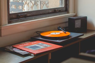 A vinyl record on the corner table by the window, afternoon light coming in from the side